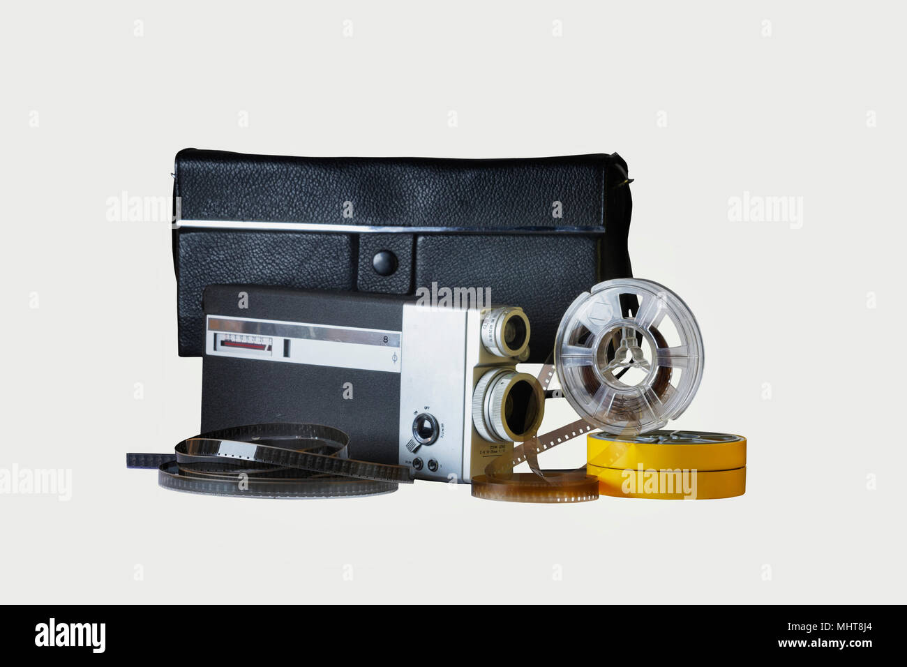 https://c8.alamy.com/comp/MHT8J4/8mm-film-camera-with-its-genuine-black-bag-one-reel-in-vertical-position-and-two-reels-in-their-yellow-holderfilm-strips-between-the-reels-MHT8J4.jpg
