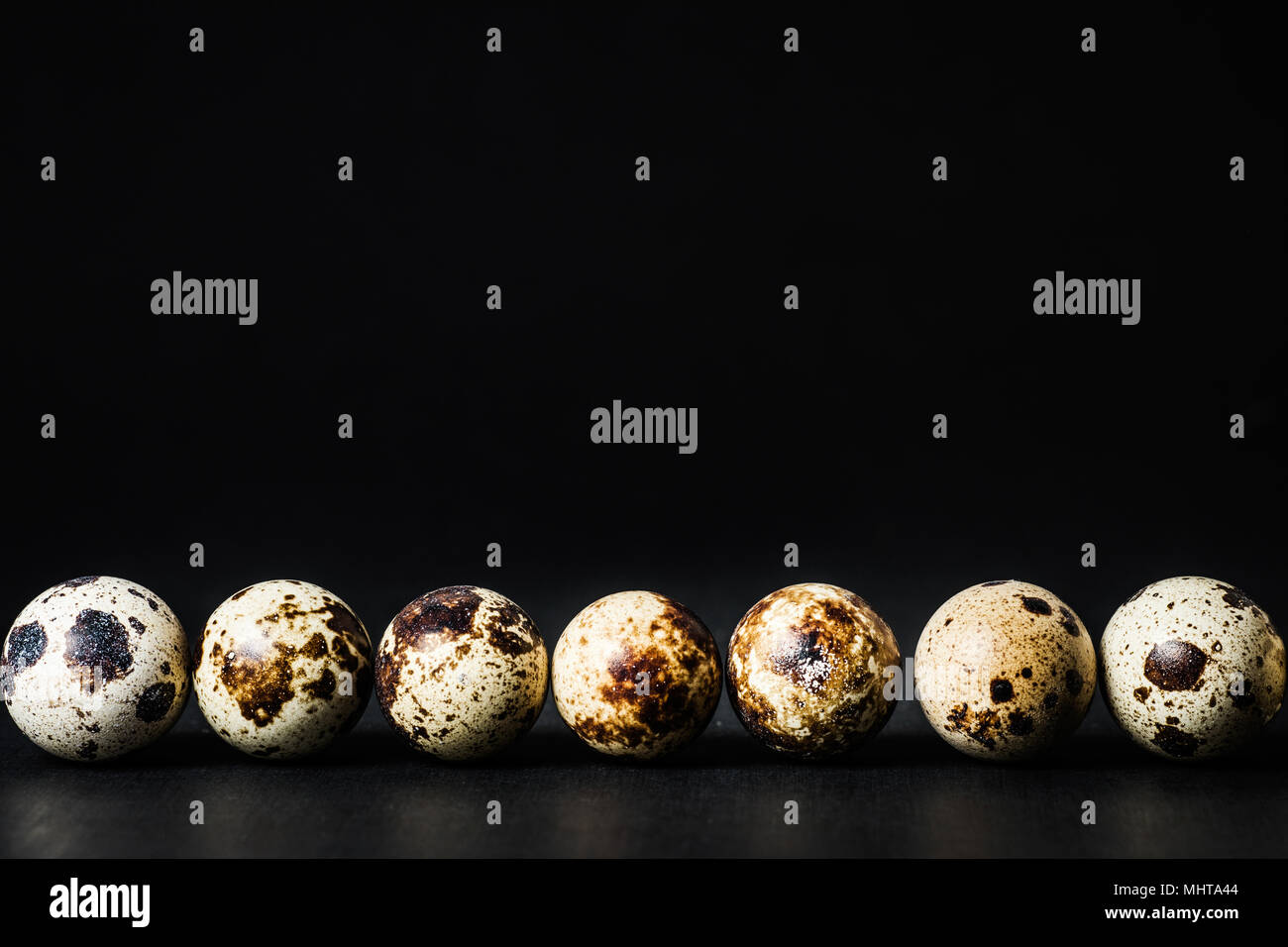 Quail eggs on dark background Stock Photo