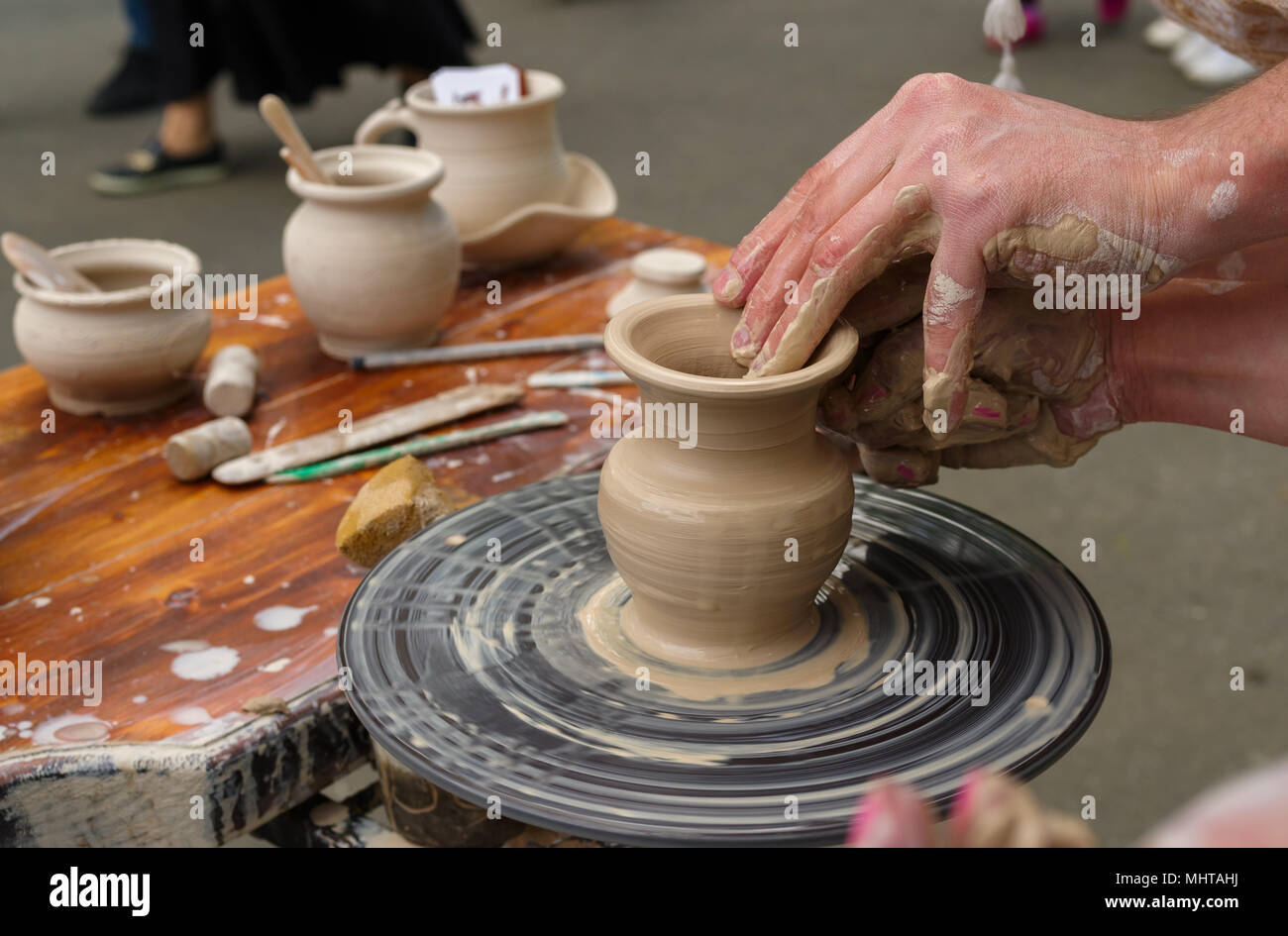 clay pitcher on a potter's wheel Stock Photo