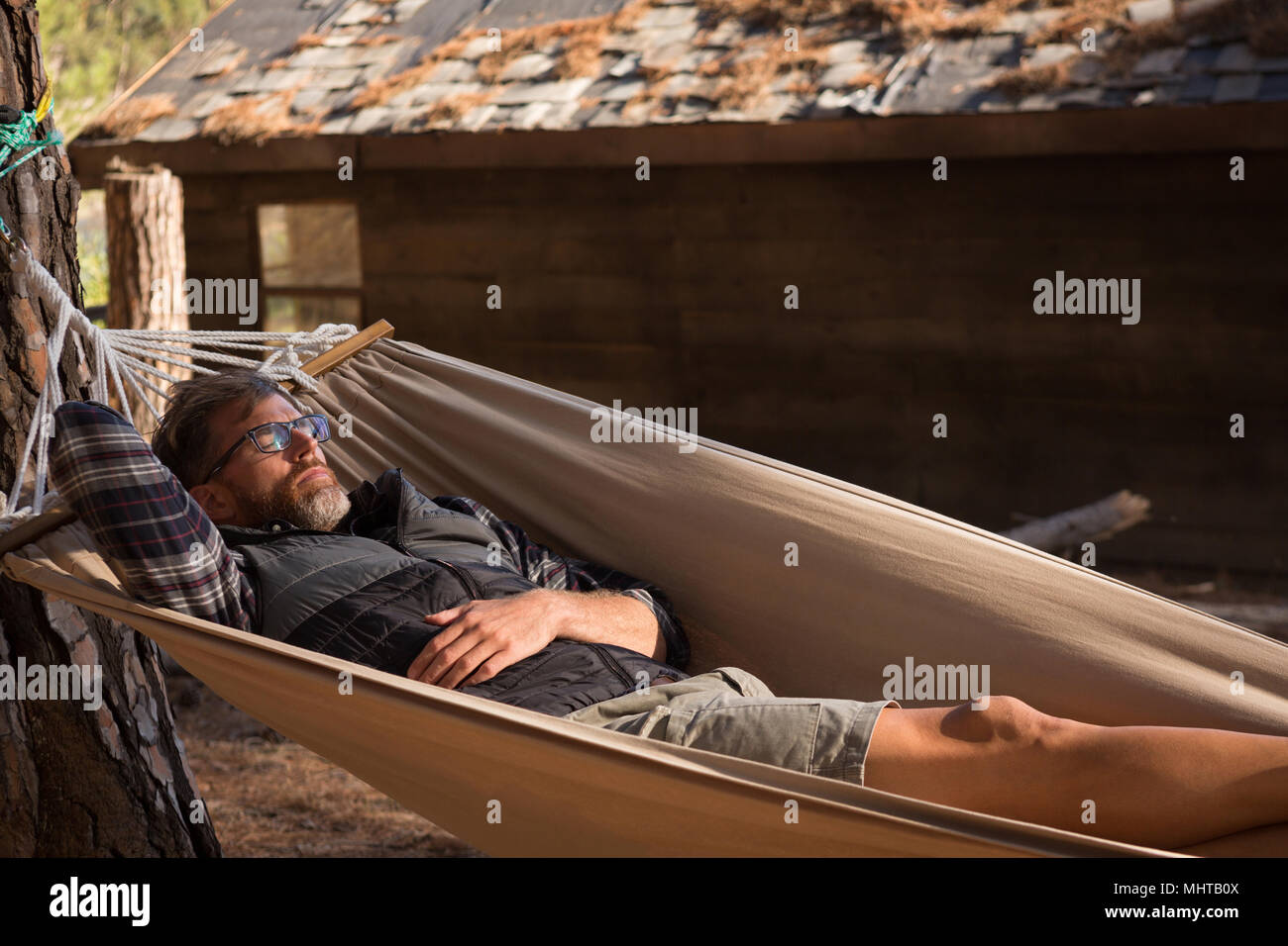 Man relaxing in hammock Stock Photo