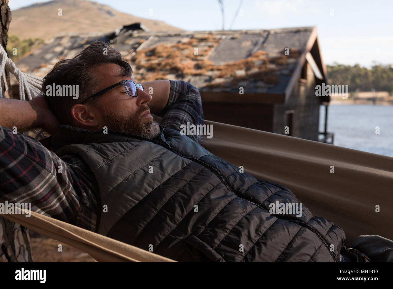 Man relaxing in hammock Stock Photo