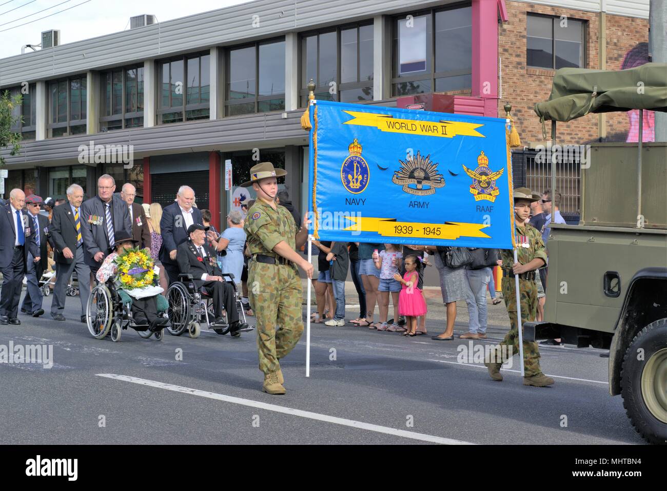 People cheer World War Two veterans in Australian city of Coffs Harbour ANZAC Day parade Stock Photo