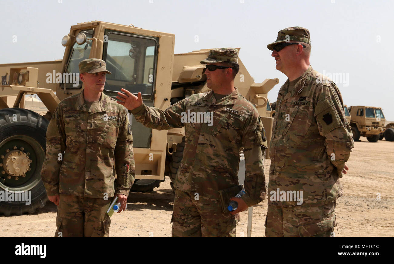 CAMP ARIFJAN, Kuwait – Staff Sgt. Patrick Shay (center), noncommissioned officer in charge of Crew 2, Bravo Battery, 1st Battalion, 62nd Air Defense Artillery Regiment, 11th Air Defense Artillery Brigade, Task Force Spartan, discusses the different procedures that soldiers are performing during a Patriot march order and emplacement on March 21, 2018.  The MO&E training took place during a visit by Maj. Gen. Andrew Shafer (right), commanding general of the 28th Infantry Division and TF Spartan, to the 1-62 ADA. (U.S. Army Stock Photo