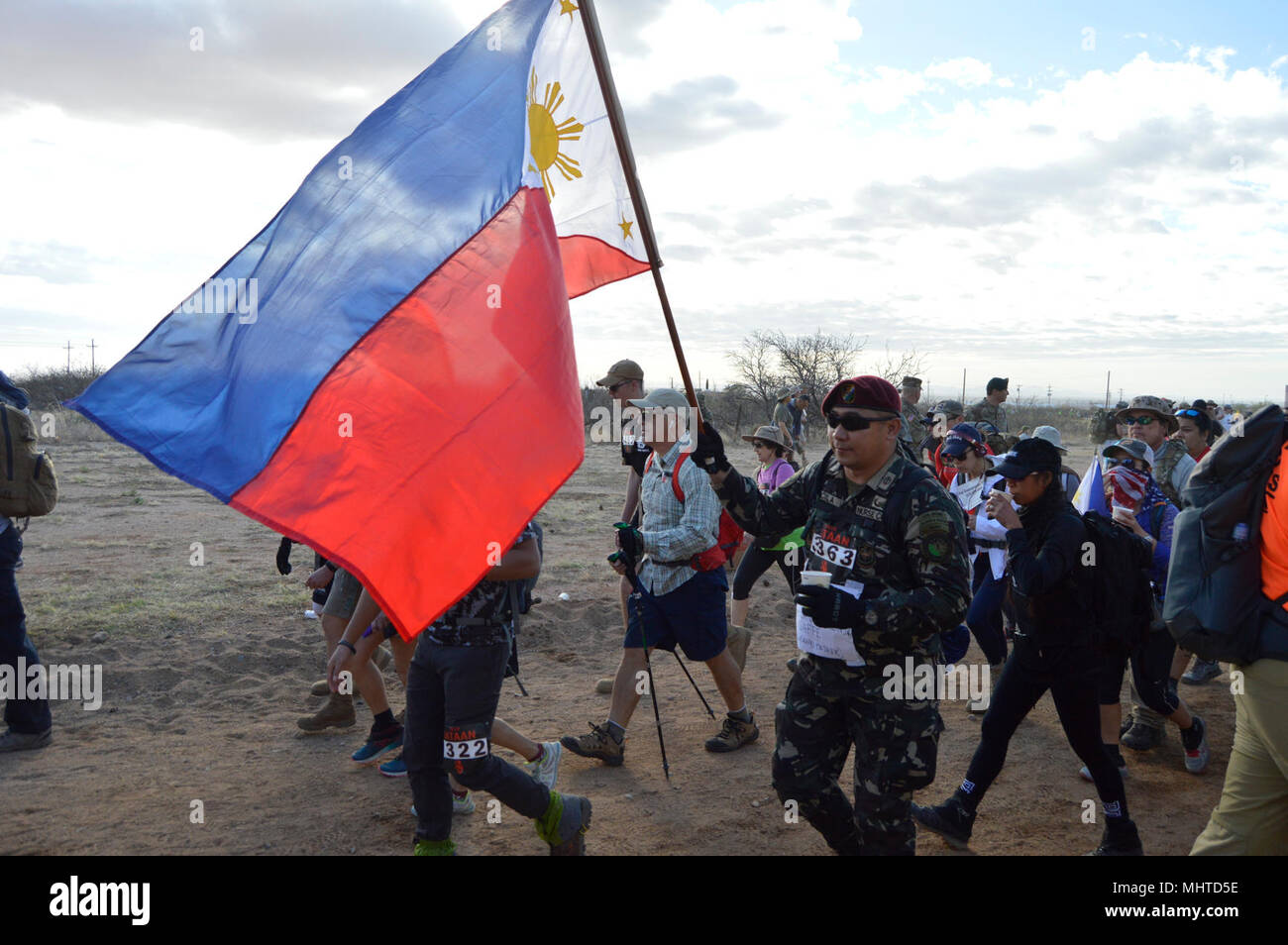 A Philippine Army Soldier proudly carries his nation’s flag during Bataan Memorial Death March at White Sands Missile Range, New Mexico, March 25, 2018. Several foreign allied countries to include Germany and Poland sent service members to participate in the event. The Bataan Memorial Death March honors the U.S. service members and Filipino soldiers that were forced marched 65 miles by the Japanese Army through the Philippine jungle in April of 1942. (U.S. Army Reserve Stock Photo