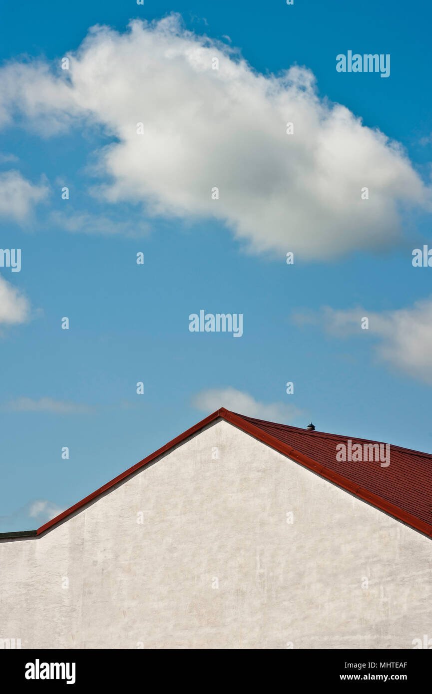 white wall and roof of a building against blue cloudy sky Stock Photo ...