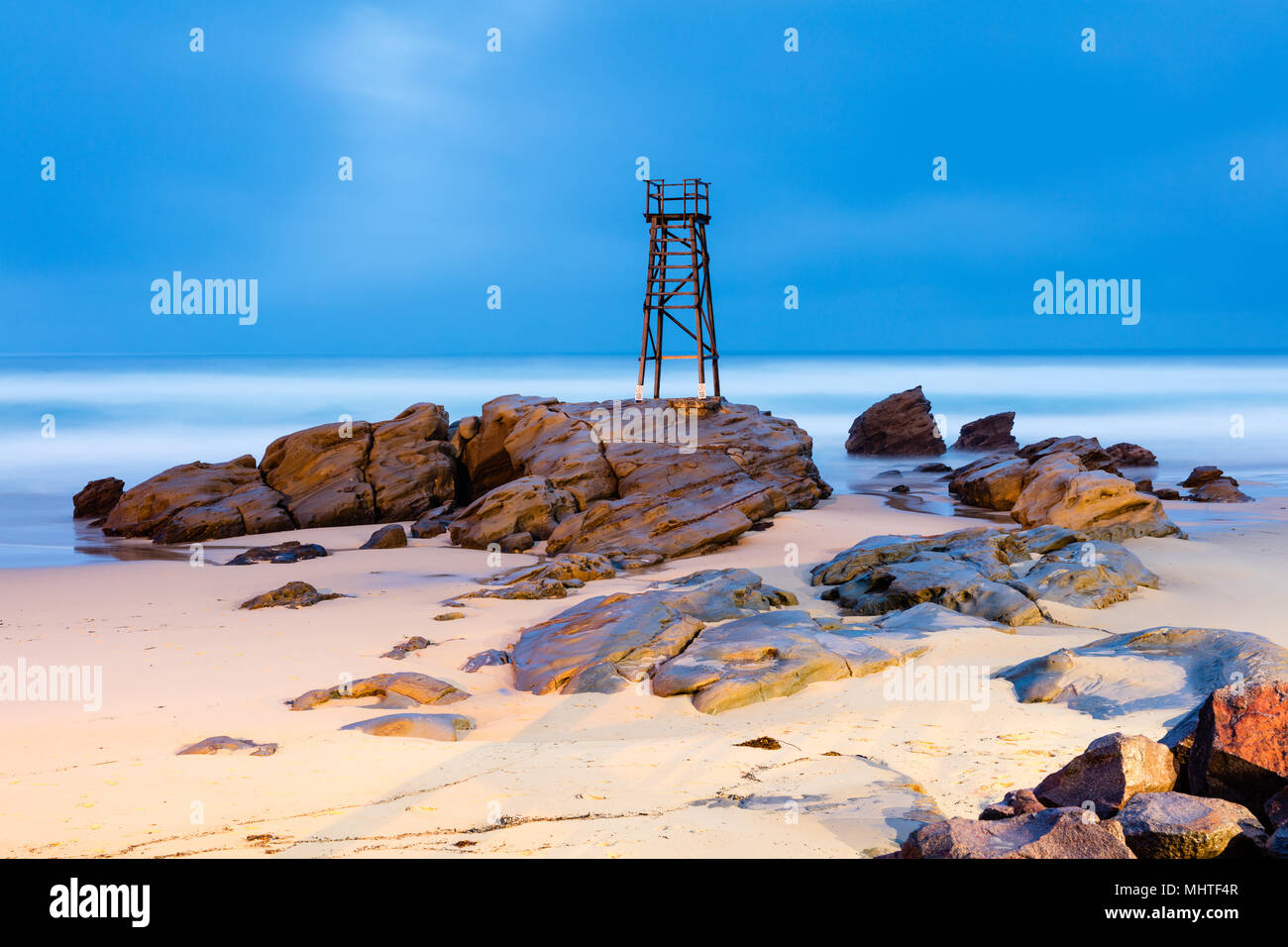 Redhead Beach, Newcastle, New South Wales, Australia. Floodlit tower at Redhead Beach near Newcastle in New South Wales on stormy and wet evening. Stock Photo