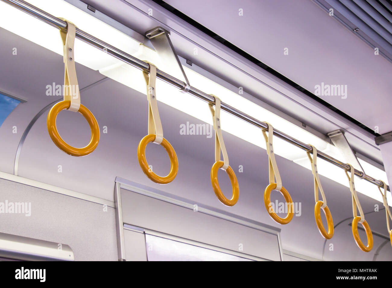 The handle on on ceiling of sky train, underground railway system or tram for safety in Japan. Stock Photo