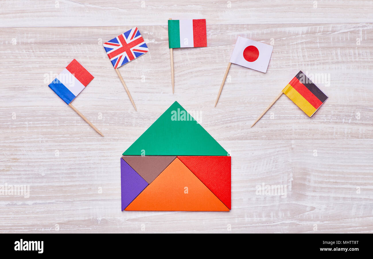 A colored house, assembled from geometric figures, with flags of different countries. Concept for language courses, translators, etc. Stock Photo