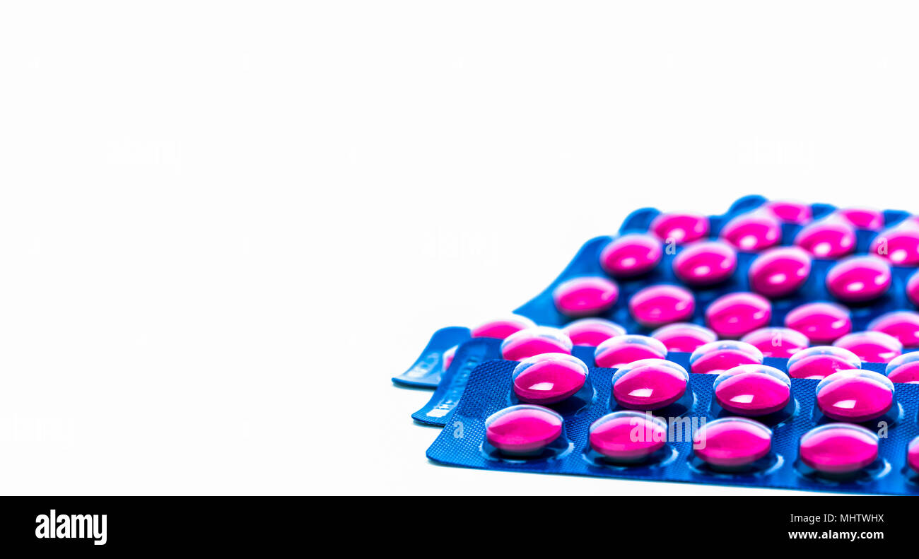 Ibuprofen in pink tablet pills pack in blue blister pack isolated on