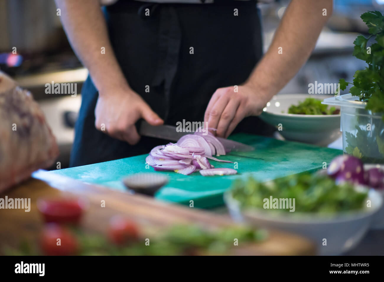 Chef hands cutting the onion with knife . Preparation for cooking ...