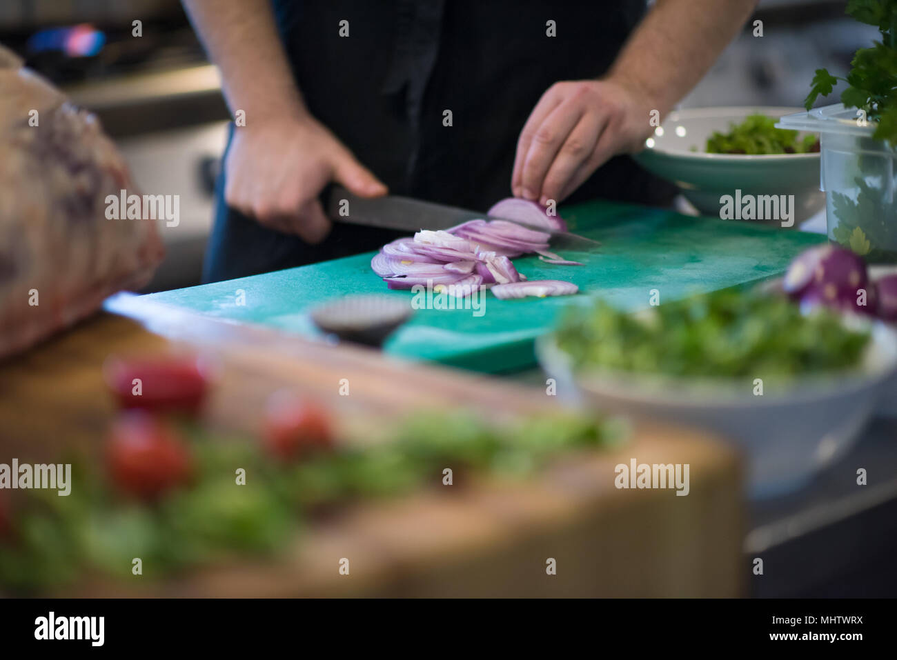 Chef hands cutting the onion with knife . Preparation for cooking ...