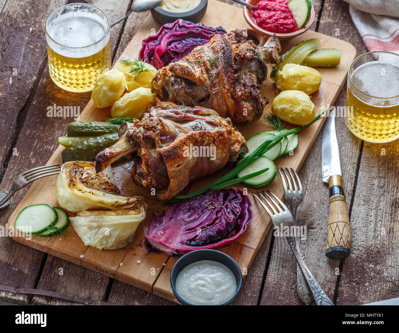 Roasted pork knuckle eisbein with braised boiled cabbage and beer Stock