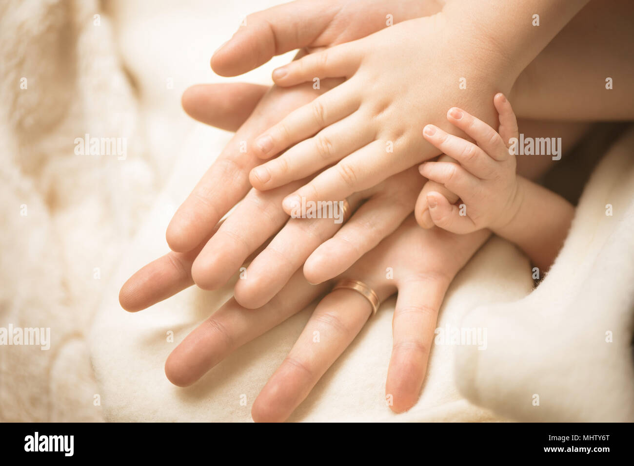Newborn child hand. Closeup of baby hand into parents hands. Family, maternity and birth concept