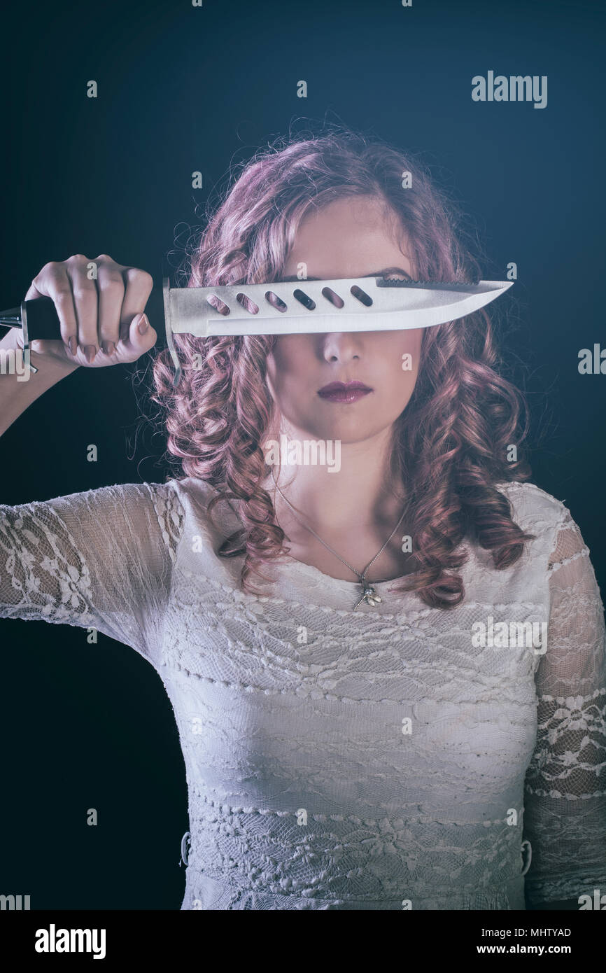Woman holding a dagger Stock Photo