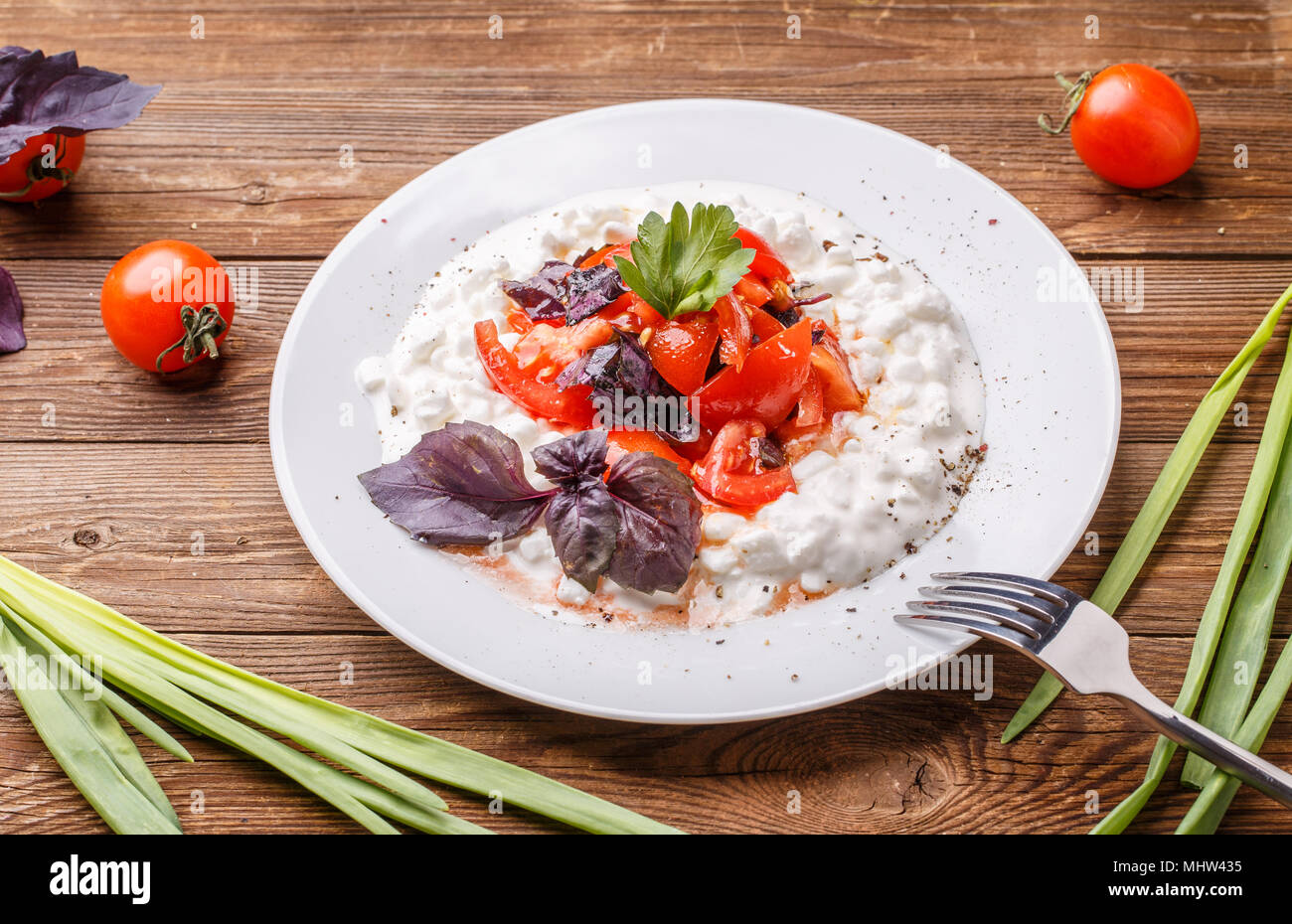 Salad With Cottage Cheese And Tomatoes On Wood Table Stock Photo