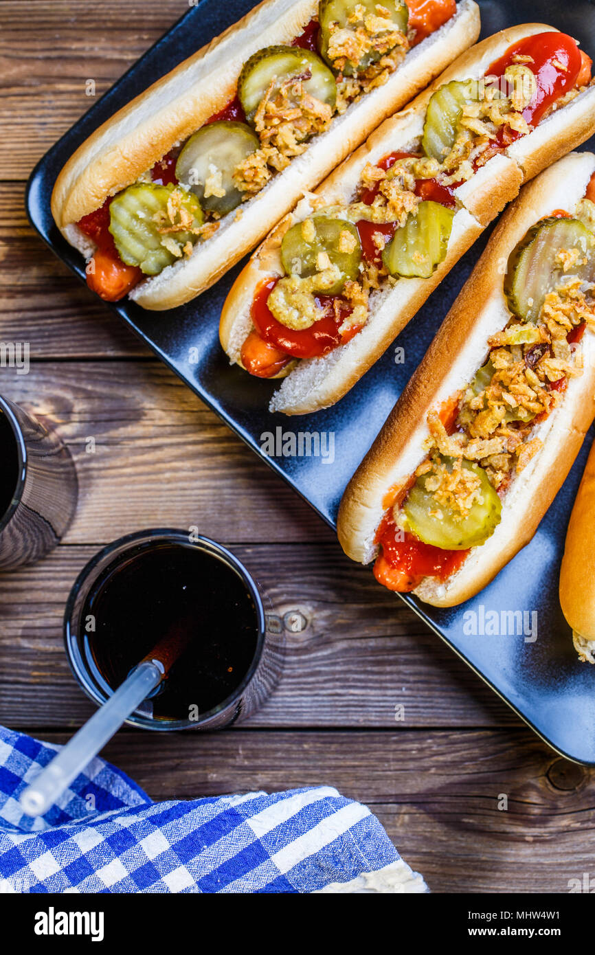 American hot dog with pickles,onions, ketchup, mustard and two soda Stock Photo Alamy