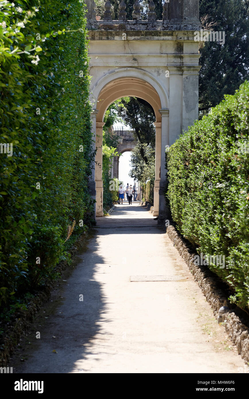 Hedged walkway with elegant archways, Villa D’Este, Tivoli, Italy. Villa D’Este, renowned for its spectacular use of water, represents the quintessenc Stock Photo