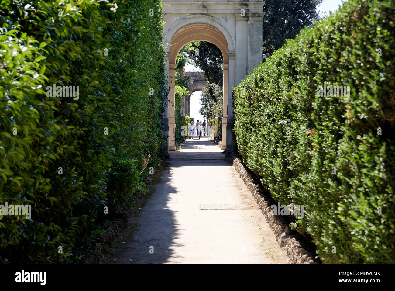 Hedged walkway with elegant archways, Villa D’Este, Tivoli, Italy. Villa D’Este, renowned for its spectacular use of water, represents the quintessenc Stock Photo