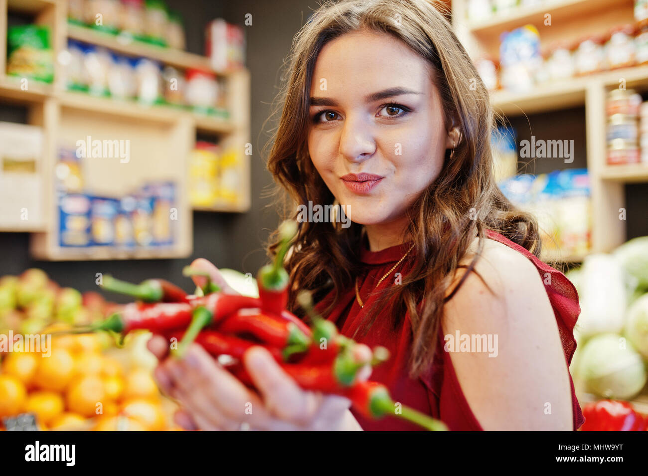 Hot girls at the store images Girl In Red Holding Hot Chili Peppers On Fruits Store Stock Photo Alamy