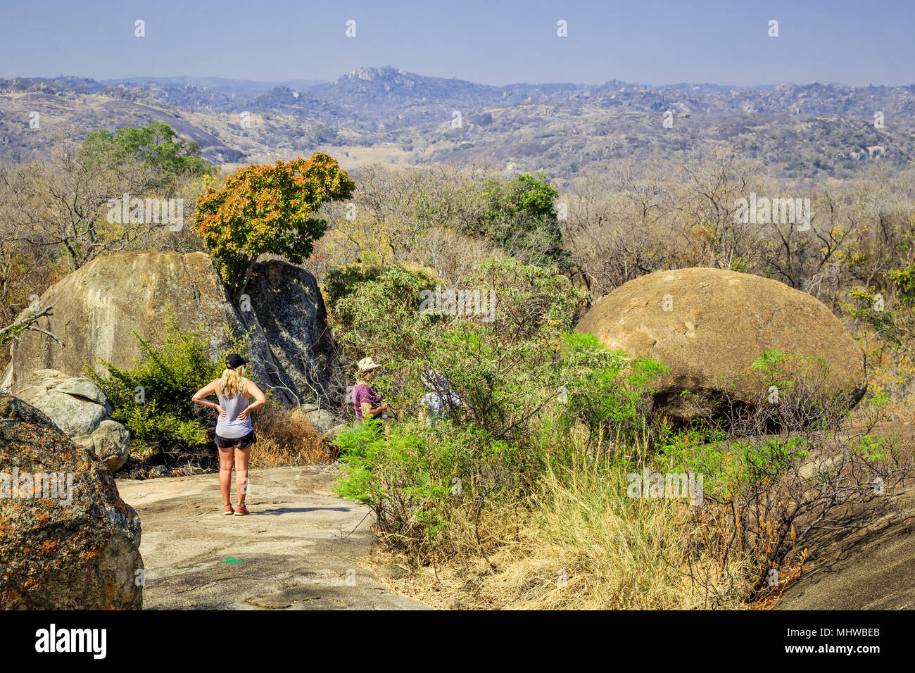 Tourists walking among the rocks in Matobo National Park, Zimbabwe ...