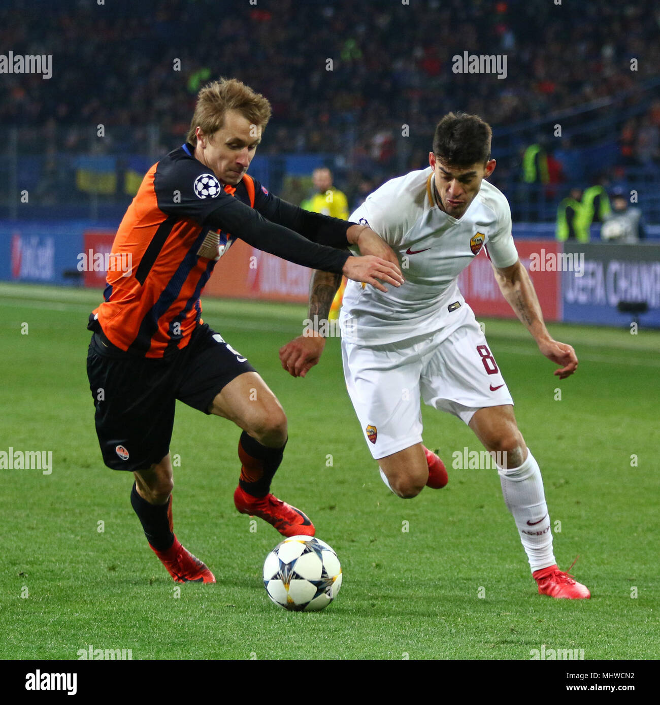 KHARKIV, UKRAINE - FEBRUARY 21, 2018: Bohdan Butko of Shakhtar Donetsk (L) fights for a ball with Diego Perotti of AS Roma during their UEFA Champions Stock Photo