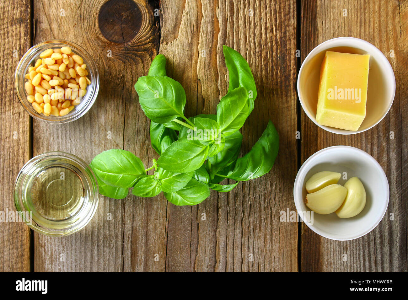 Ingredients for pesto sauce. Cheese, garlic, basil, pine nuts, olive oil Stock Photo
