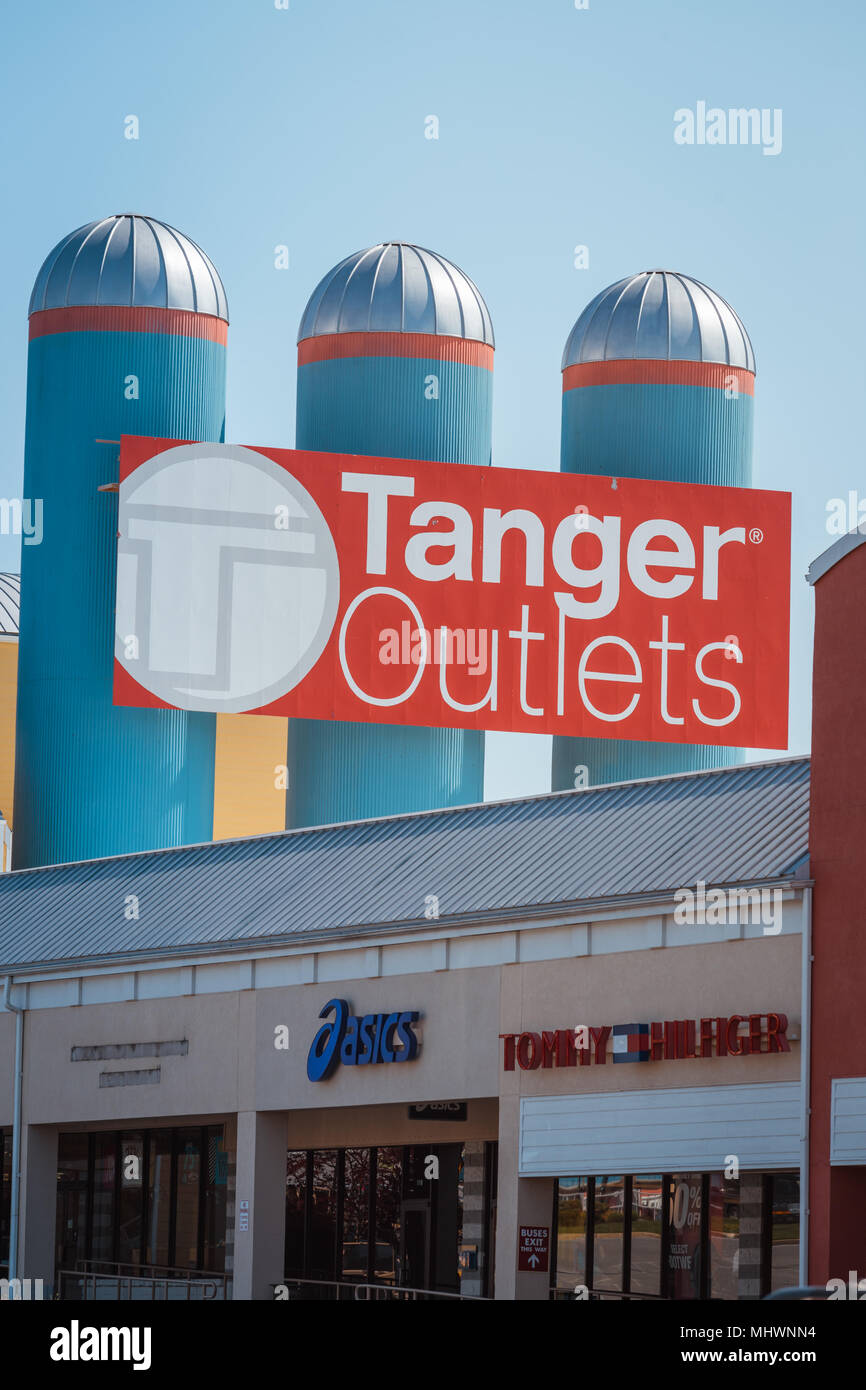 Lancaster, PA, USA - May 2, 2018: The Tanger Outlets sign on three silos. Tanger is a shopping-mall chain featuring brand-name and designer outlet sto Stock Photo