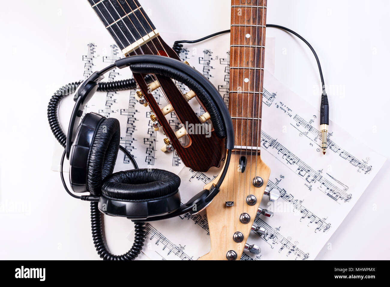 Electric guitar and headphones with music notes. Stock Photo