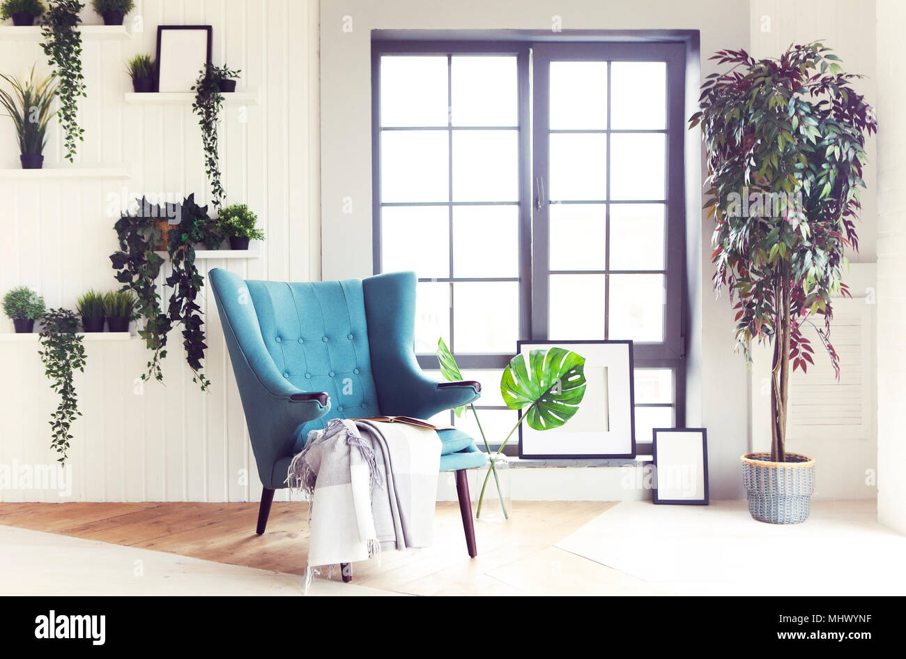 Modern interior of cozy living room with armchair and plants Stock ...