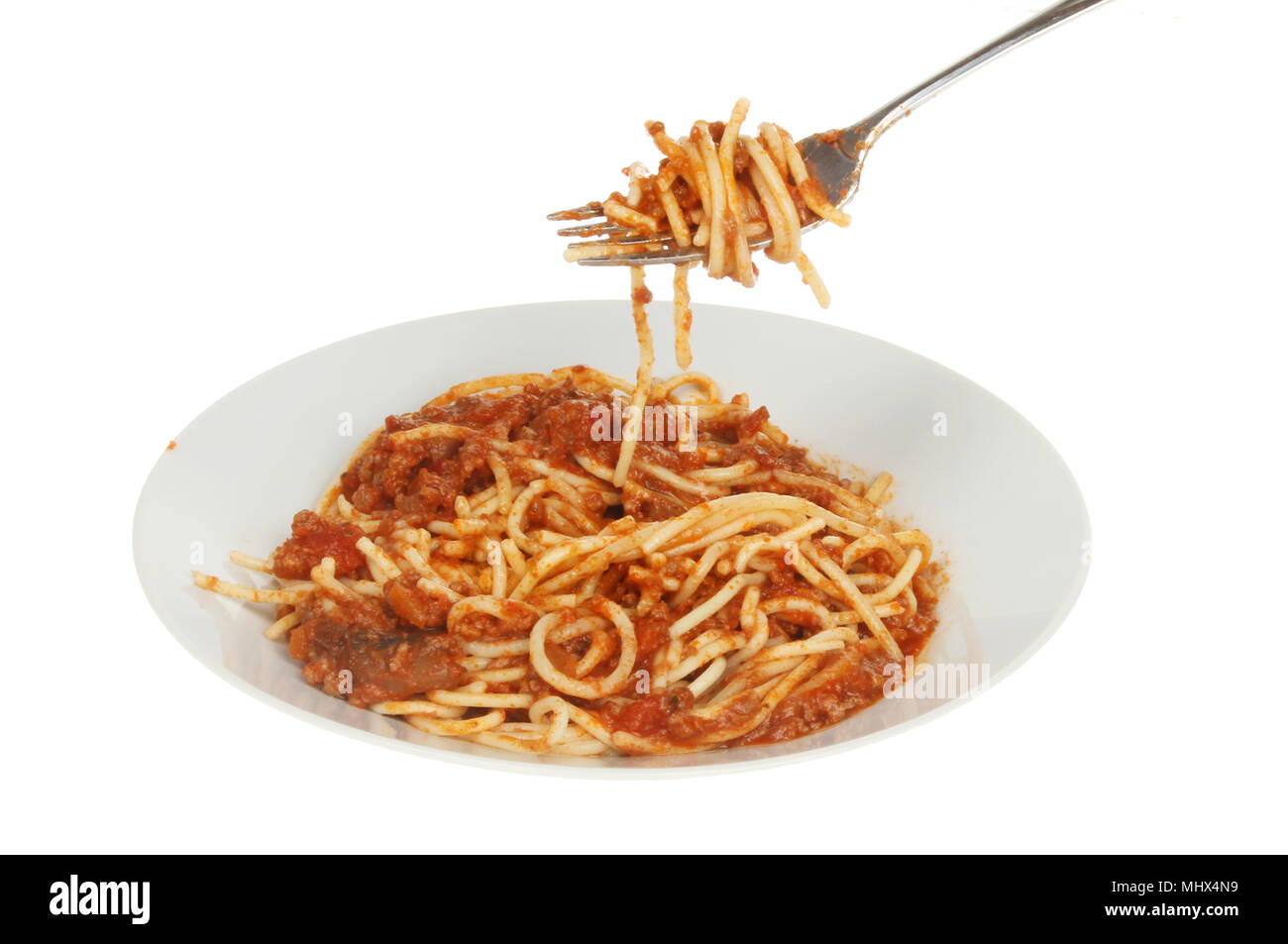 Spaghetti bolognese ina bowl with a fork isolated against white Stock Photo