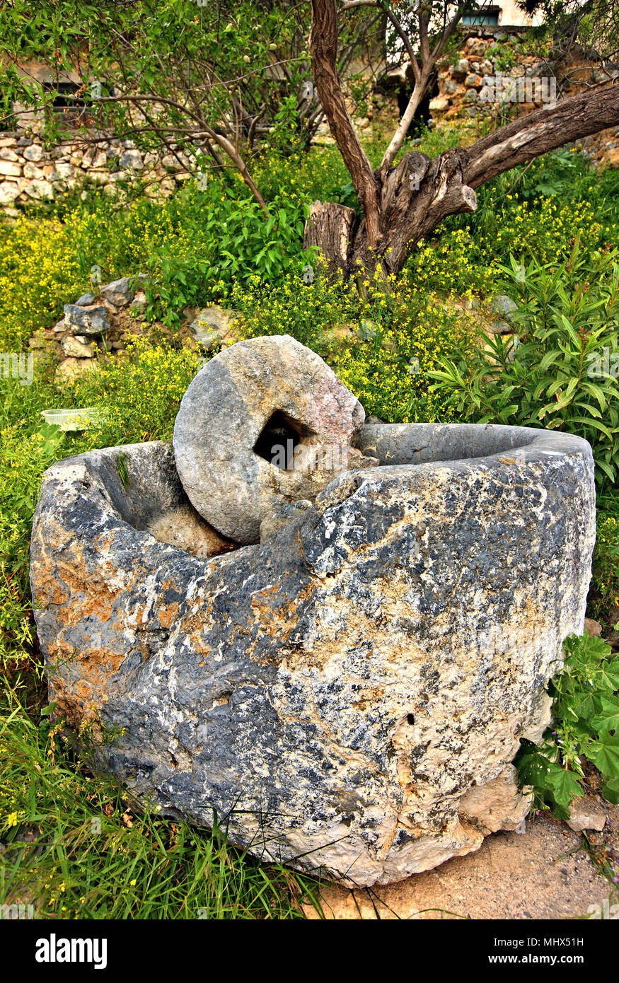 Old millstone in Anatoli village, one of the most beautiful mountainous villages of Ierapetra municipality, Lasithi, Crete, Greece. Stock Photo