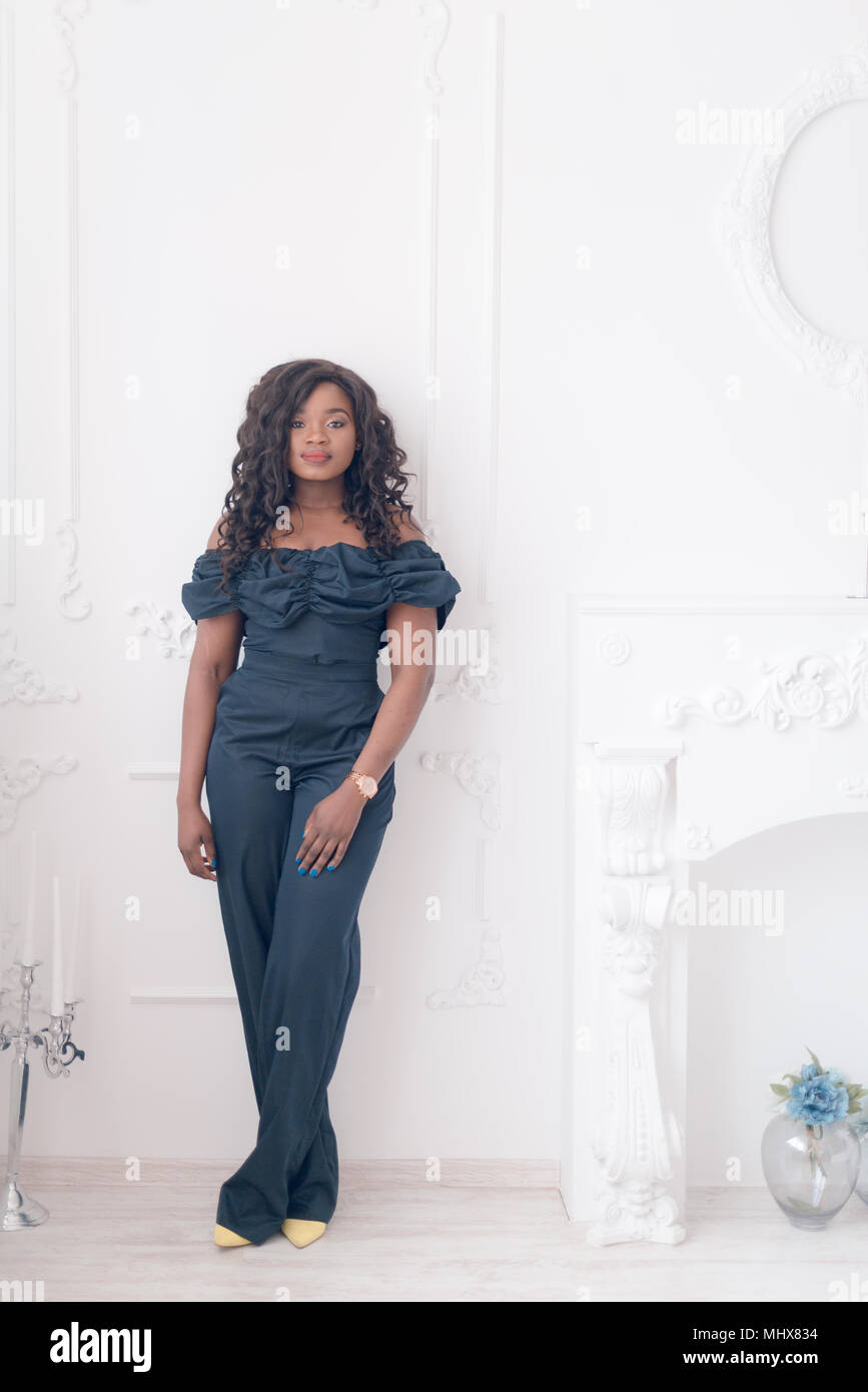 Beautiful young african american girl posing in studio, looking at ...