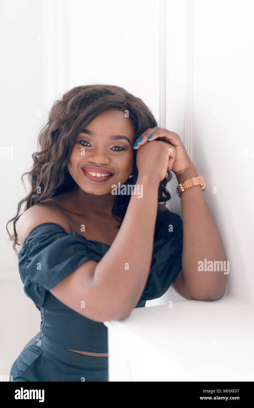Beautiful young african american girl posing in studio, looking at ...