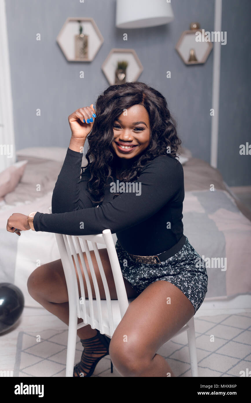 Beautiful young african american girl posing in studio, looking at ...