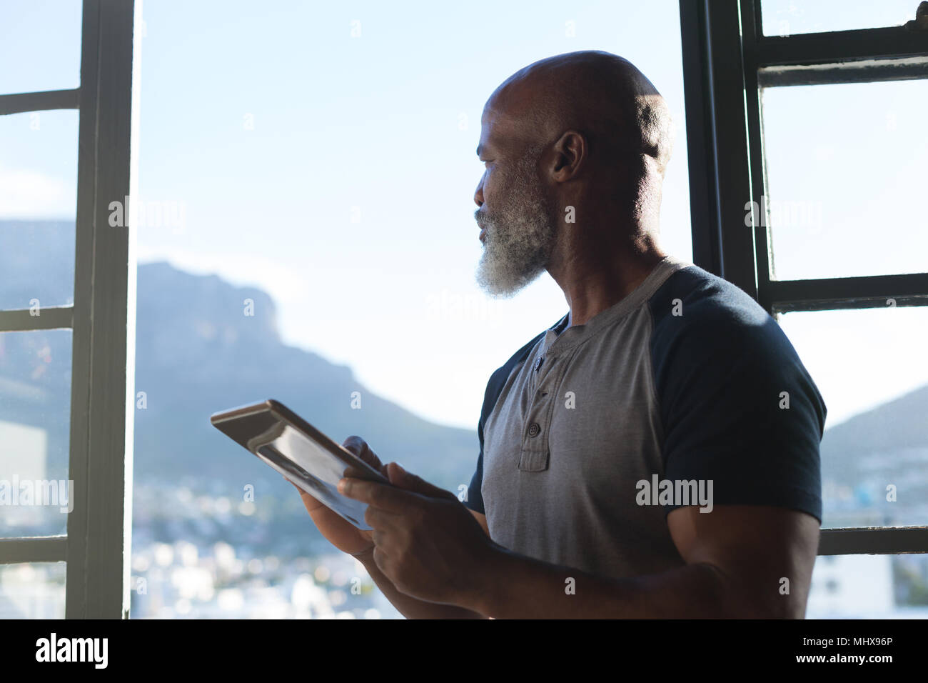 Smiling senior man using digital tablet Stock Photo