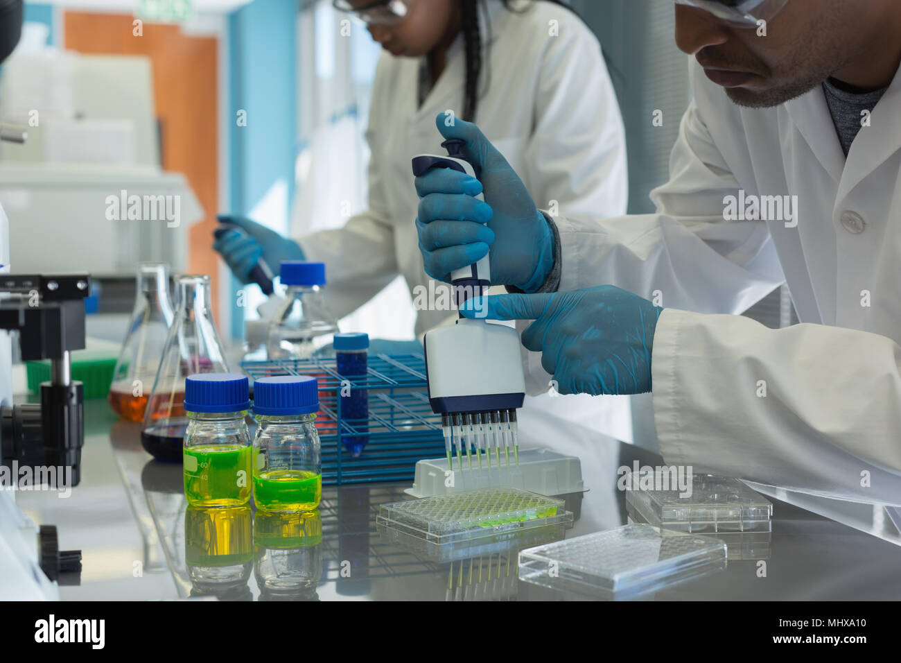 Scientists doing experiment in lab Stock Photo