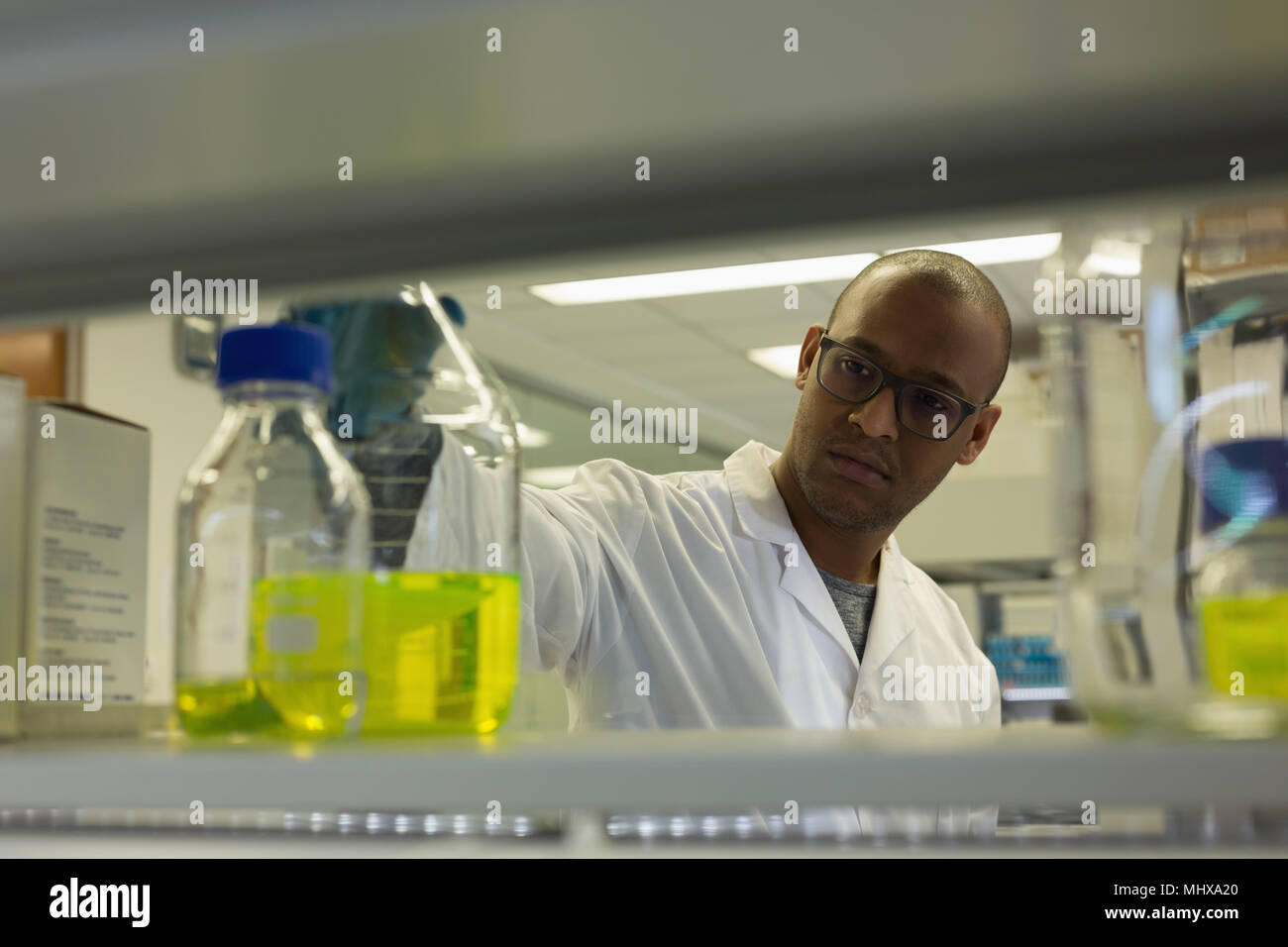 Scientist checking a solution in conical flask Stock Photo