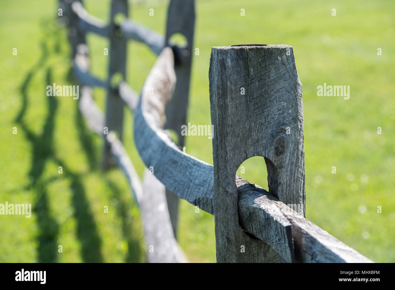 old wood fence on green grass background view Stock Photo - Alamy