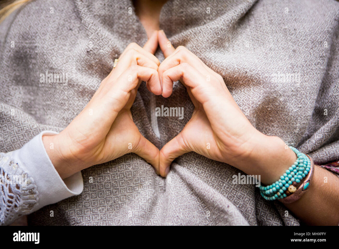 Young woman's hands making heart shape, cropped Stock Photo