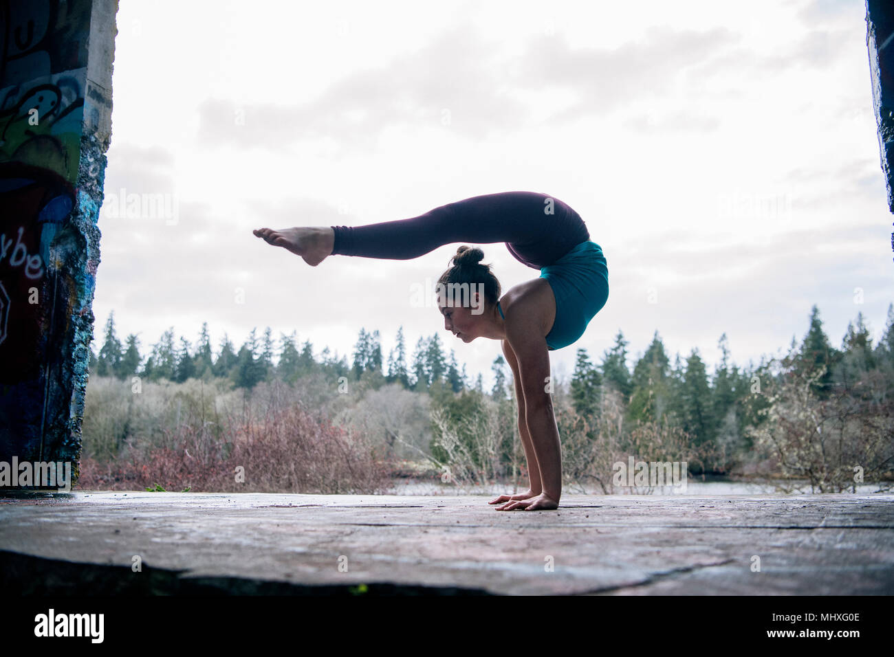 Girl practising yoga on outdoor stage Stock Photo