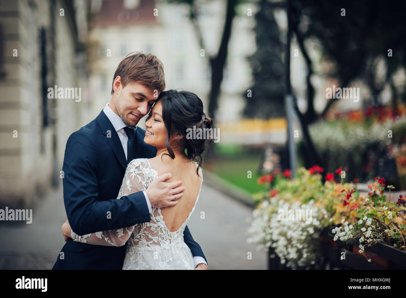 Bride groom hugging in city hi-res stock photography and images - Alamy
