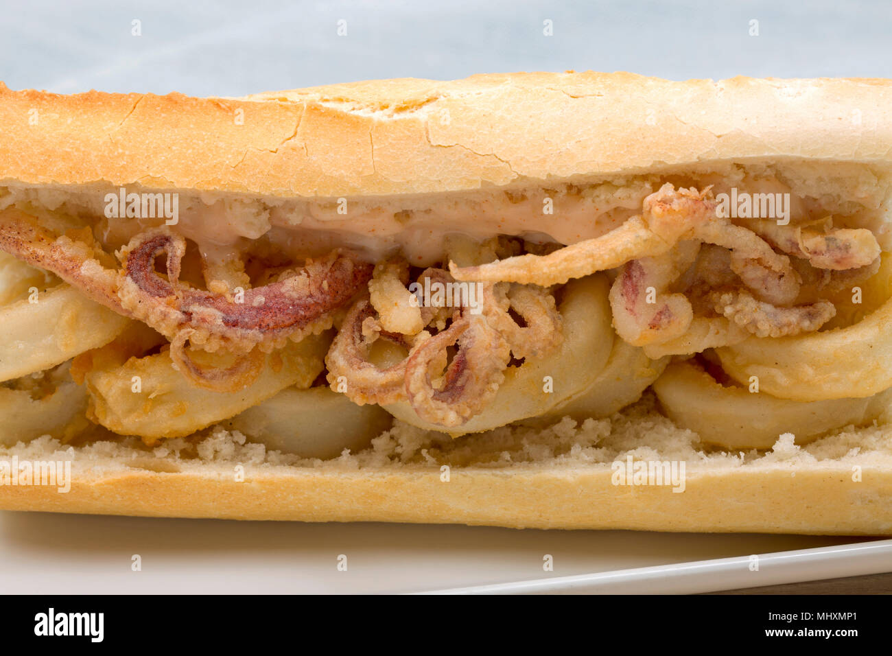A Bocadillo de Calamares, or squid sandwich. The squid used were Loligo  vulgaris that were caught in the UK on rod and line. The squid is dipped in  fl Stock Photo -