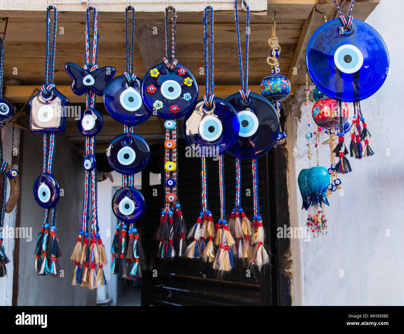 Evil eye bead souvenirs.broken glass is melted and shaped. In culture and  religious belief, the figure of the eye is regarded as a powerful amulet  pro Stock Photo - Alamy