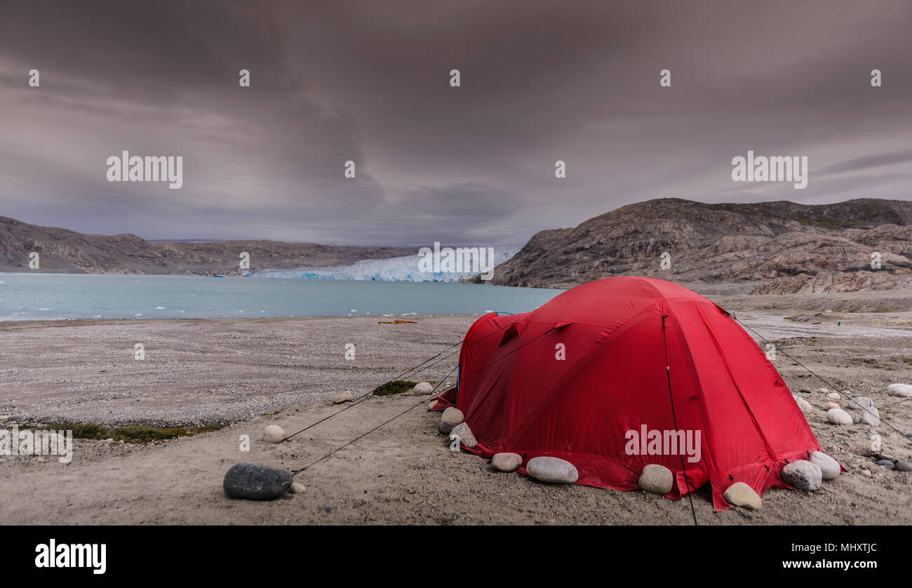 Red tent pitched in front of Qualerallit glacier, Narsaq, Kitaa, Greenland Stock Photo