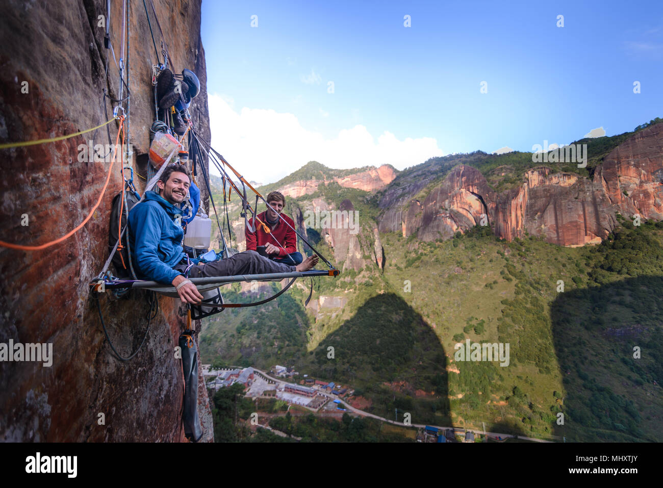 Portrait of two rock climbers on portaledge, Liming, Yunnan Province, China Stock Photo