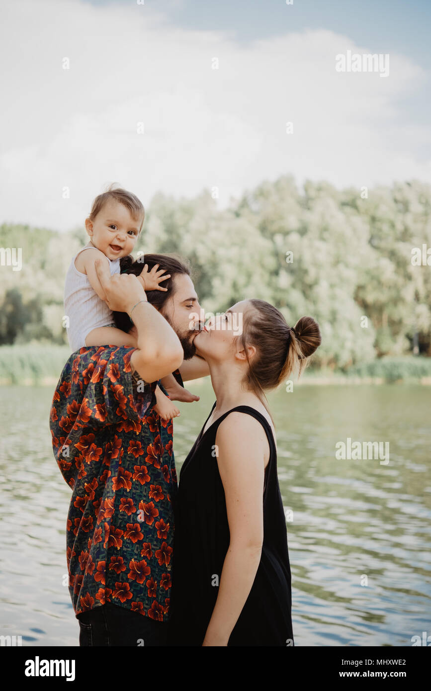 Couple with baby girl by lake, Arezzo, Tuscany, Italy Stock Photo