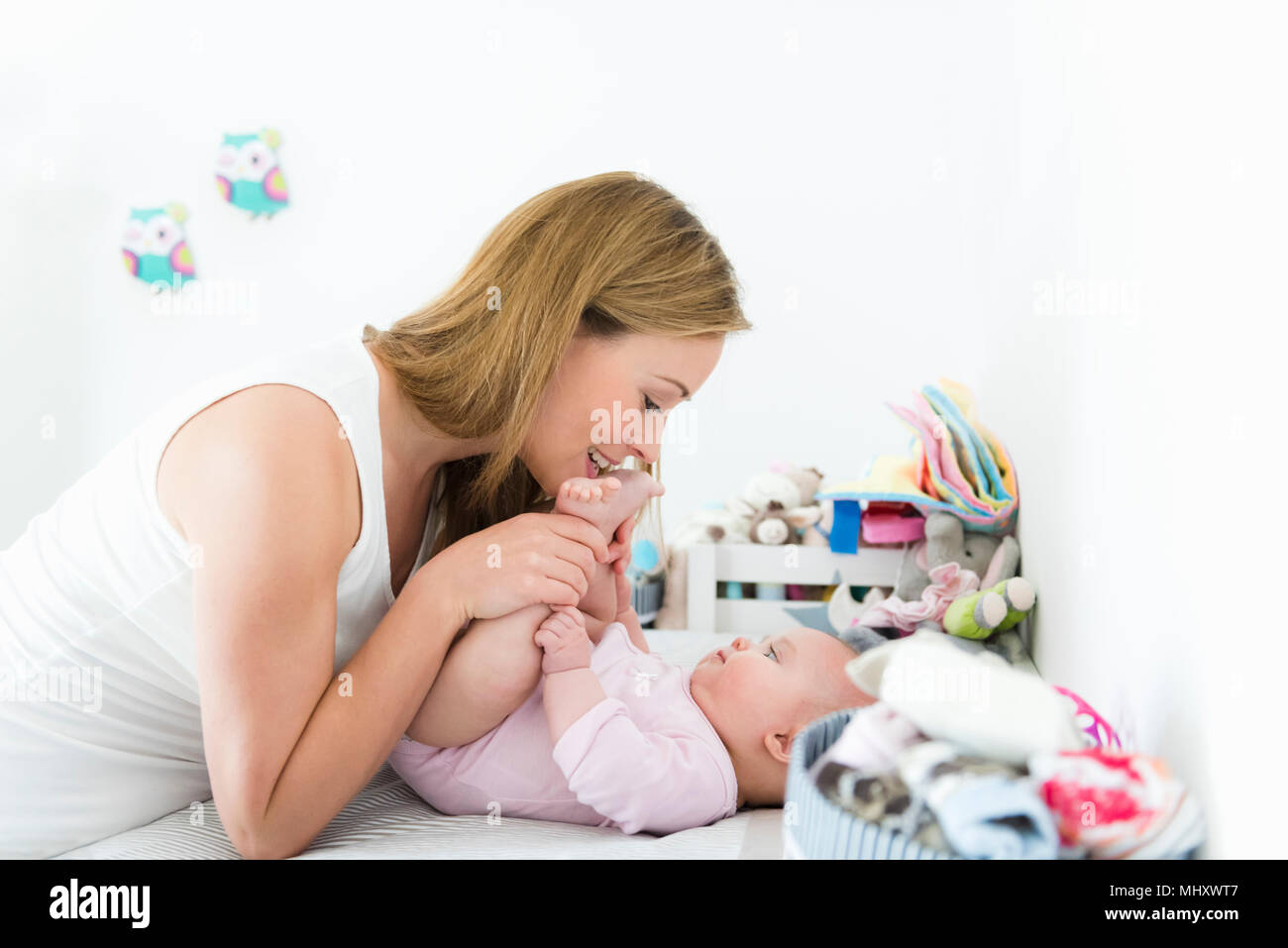 Baby girl on changing diaper table hires stock photography and images