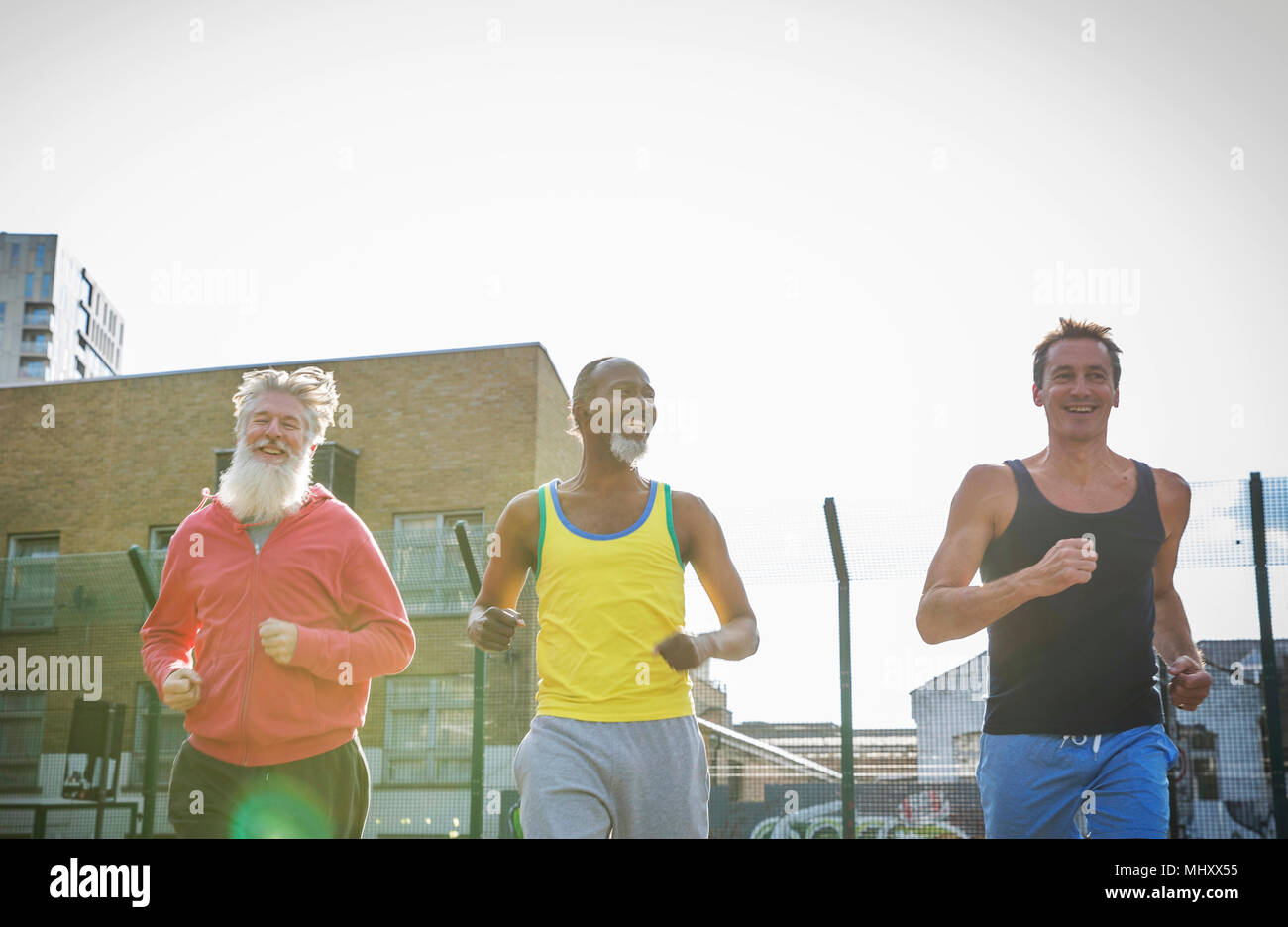 Three mature men, outdoors, jogging, low angle view Stock Photo