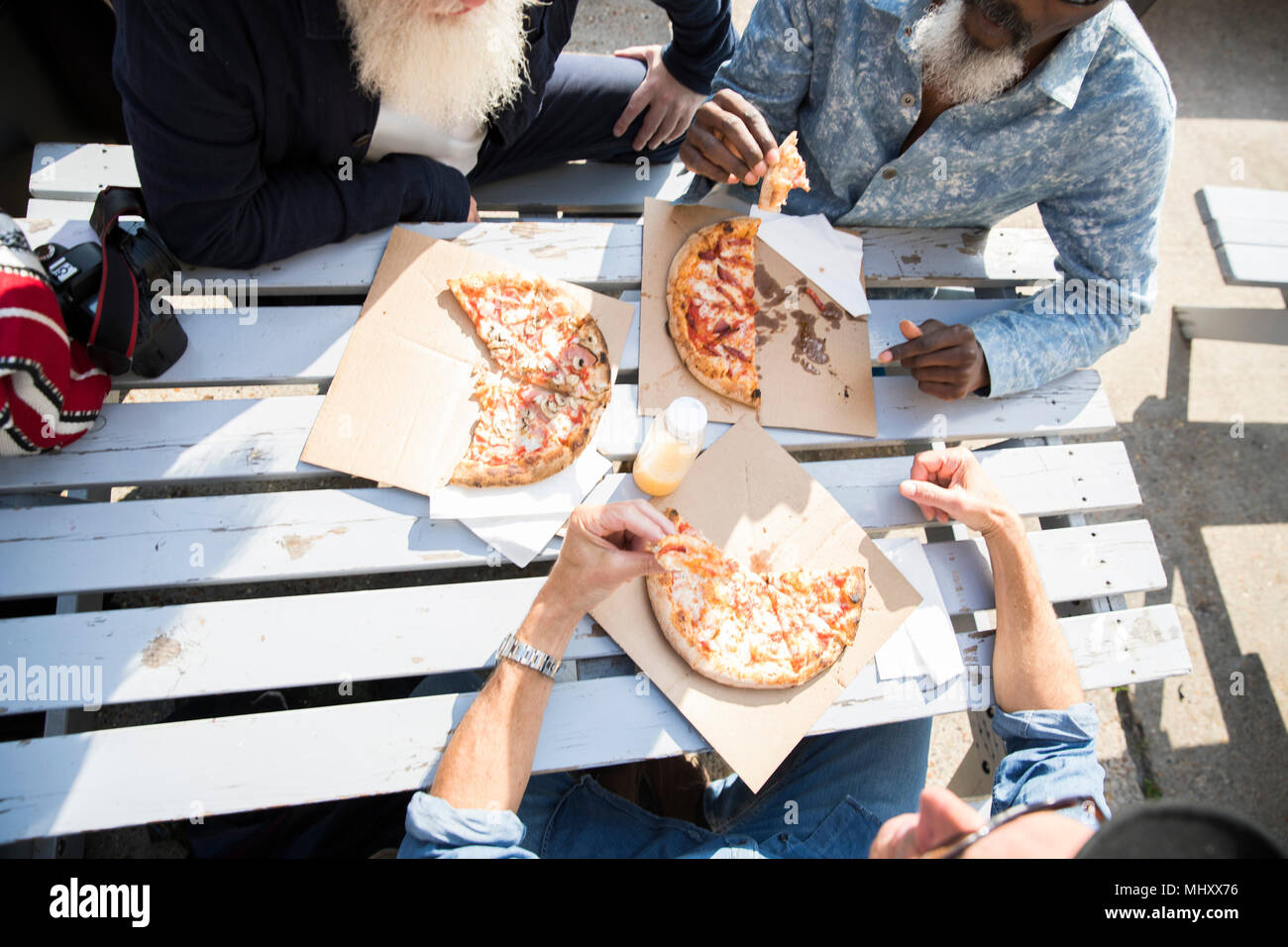 Friends having pizza outdoors Stock Photo