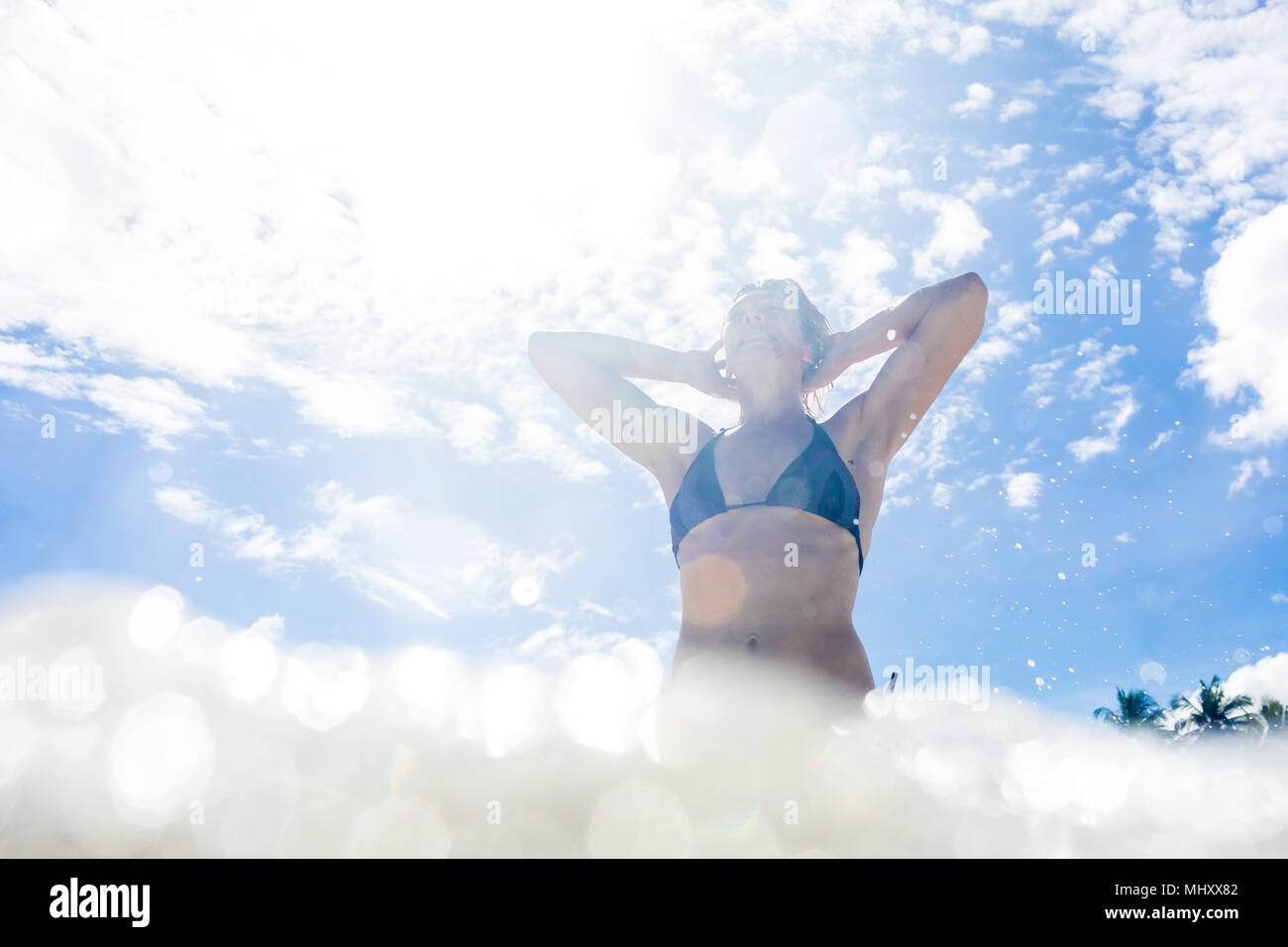 Woman in sea, low angle view, Nacpan Beach, Palawan, Philippines Stock Photo